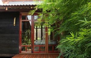 una puerta de cristal de una casa con plantas en The Happy 8 Retreat en Ipoh