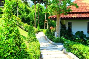 a garden path in front of a house at Bakantiang Resort in Ko Lanta