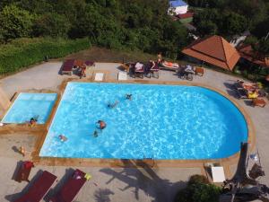 an overhead view of a swimming pool with people in it at Bakantiang Resort in Ko Lanta