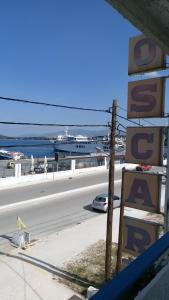 a view of a road with a cruise ship in the water at Hotel Oscar in Igoumenitsa
