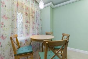a room with a table and two chairs at Feelathome Apartments - Nevsky in Saint Petersburg