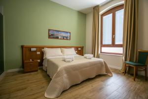 特拉尼的住宿－Residence Trani，一间卧室设有一张大床和一个窗户。