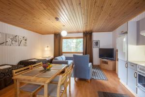 a kitchen and living room with a table and a couch at Poukama in Porvoo