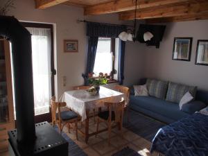a living room with a table and a couch at Kellerstöckl Prantner in Rechnitz