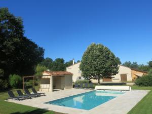 a swimming pool in the backyard of a house at Domaine De Cimélia in Fauch