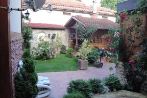an outside view of a garden with flowers and plants at Guest House Zlatev in Bansko