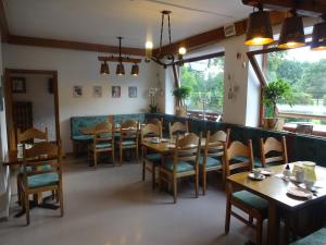 a dining room with wooden tables and chairs at Hotel Garni Schlossblick in Hohenschwangau