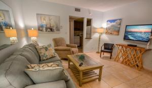 a living room with a couch and a table at Sea Cliff Hotel in Fort Lauderdale