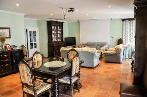 a living room with a couch and a table and chairs at Chalet San Bernardo in Toledo