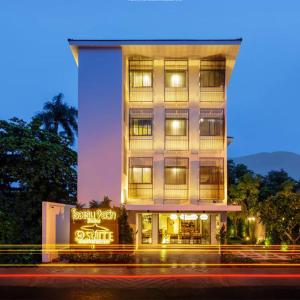 a tall building with a sign in front of it at 9 SUITE Luxury Boutique Hotel in Chiang Mai
