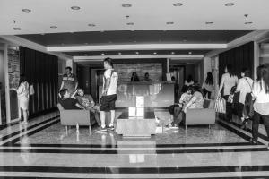 a black and white photo of a group of people in a room at Daichi Place Megatower Residences in Baguio