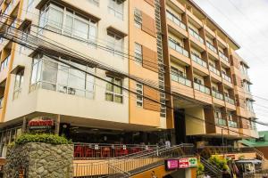 a large apartment building with a balcony at Daichi Place Megatower Residences in Baguio