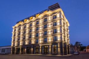 a large white building with lights on at Best Western Kutaisi in Kutaisi