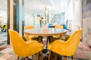 a dining room table with chairs and tables at Sangate Hotel Airport in Warsaw