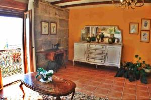 a living room with a table and a fireplace at Casa Combarro in Combarro