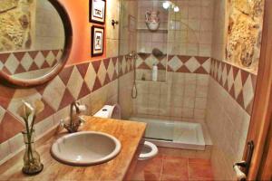 a bathroom with a sink and a toilet and a mirror at Casa Combarro in Combarro +22 photos