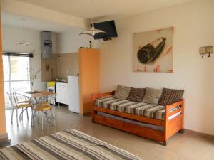 a bedroom with a bed and a kitchen with a table at HM San Jose in San José