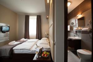 Posteľ alebo postele v izbe v ubytovaní Hotel Villa Völgy Wellness & Konferencia