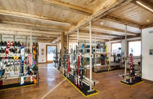 a room filled with lots of skis on display at Hotel Arnika Wellness in Passo San Pellegrino