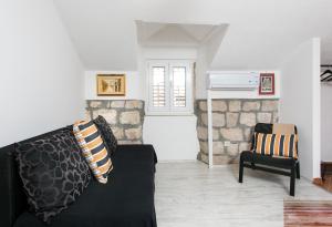 a living room with a couch and a chair at Apartments Heart of Dubrovnik in Dubrovnik