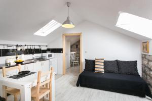 a living room and kitchen with a bed and a table at Apartments Heart of Dubrovnik in Dubrovnik