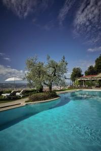 a swimming pool with blue water in a resort at Villa San Michele, A Belmond Hotel, Florence in Fiesole