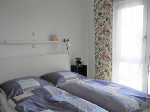 a bedroom with a bed and a window with at Gästehaus 26/2 in Bad Urach