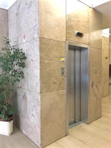 an elevator in an office building with a door at Affittacamere Pratello 97 in Bologna