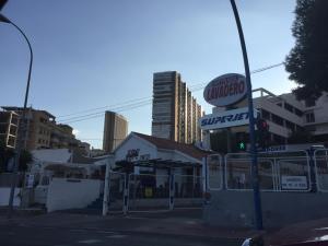 a fast food restaurant on a city street with buildings at First line Apartment in Alicante
