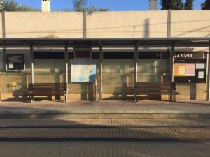 a bus stop with two benches at a train station at First line Apartment in Alicante