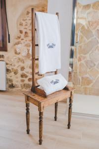 a towel sitting on top of a wooden chair at Navazos loft in Benaocaz