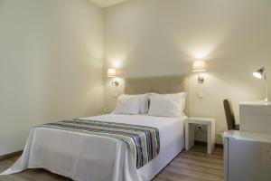 Postel nebo postele na pokoji v ubytování Porto Domus Hotel