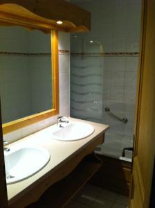 uma casa de banho com 2 lavatórios e um chuveiro em Studio d'Anaite em Les Houches