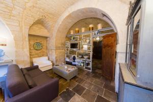 a living room with a couch and a table at Luxury Cave Modica in Modica