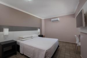 Postel nebo postele na pokoji v ubytování Hotel Sete Coqueiros