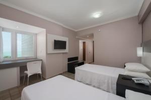 Postel nebo postele na pokoji v ubytování Hotel Sete Coqueiros