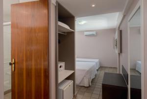 Postel nebo postele na pokoji v ubytování Hotel Sete Coqueiros