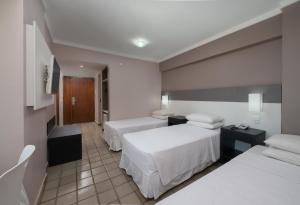 Postel nebo postele na pokoji v ubytování Hotel Sete Coqueiros