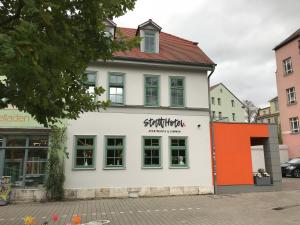 a white building with the words patriarchy on it at stattHotel Weimar in Weimar