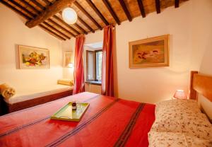 a bedroom with a bed with a tray on it at Agriturismo biologico il Molinaccio al Rio Chiaro in Civitella dʼAgliano
