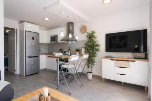 a kitchen and living room with a table and chairs at Bungalow en Maspalomas in Maspalomas