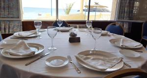 a table with plates and wine glasses on it at Bahía - 30º hotels in Puerto de Mazarrón +49 photos