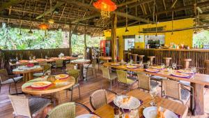 a dining room with wooden tables and chairs at Hakuna Matata Amazon Lodge in Archidona