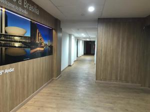 a hallway of an office with a large poster on the wall at MIX APART Hotel in Brasília