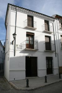 un edificio blanco con 2 balcones y una puerta en Casa Rural Villalta, en Priego de Córdoba