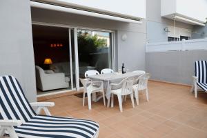 a white table and chairs on a patio at Llucmajor 29 in Mahón