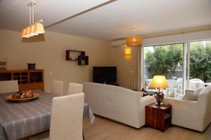 a living room with a couch and a table and chairs at Llucmajor 29 in Mahón