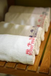 two towels with writing on them sitting on a table at Flying Cow Ranch in Tongxiao