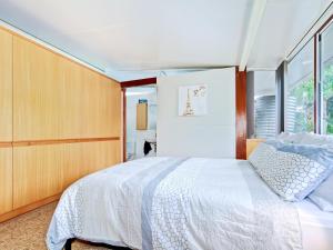 a bedroom with a white bed and a window at Perla del Mare - Aldinga Beach - C21 SouthCoast Holidays in Aldinga Beach