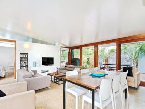 a living room with a table and chairs at Perla del Mare - Aldinga Beach - C21 SouthCoast Holidays in Aldinga Beach